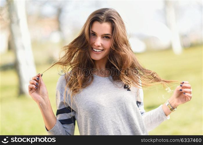 Portrait of a pretty woman smiling in a urban park