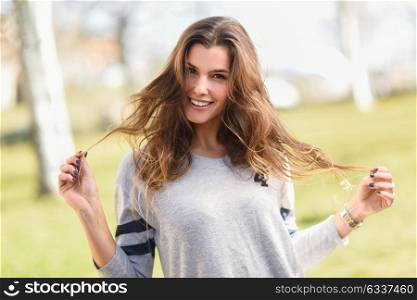 Portrait of a pretty woman smiling in a urban park