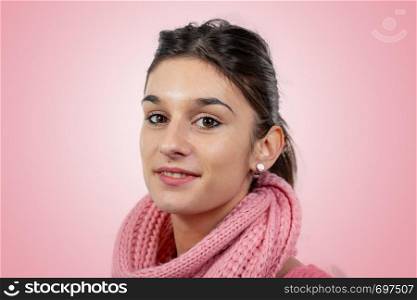 portrait of a pretty young brunette with a pink sweater