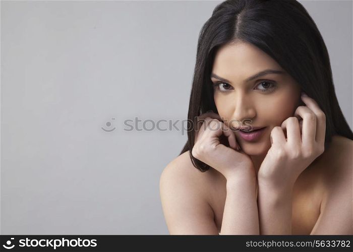 Portrait of a pretty young female with long hair over colored background