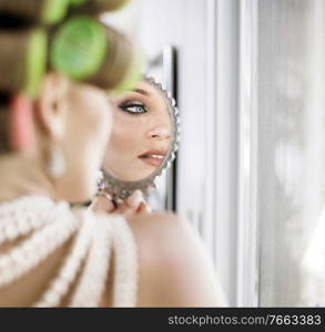 Portrait of a pretty young woman doing a makeup