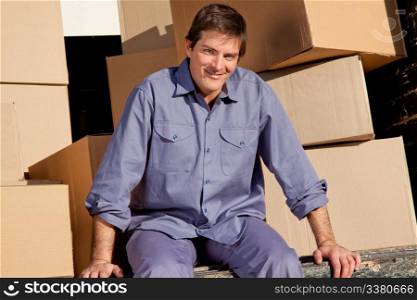 Portrait of a professional mover on the deck of a moving truck