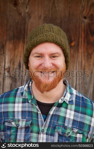 Portrait of a red haired hipster guy putting silly face
