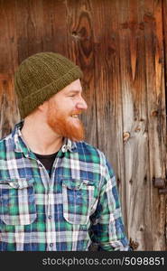 Portrait of a red haired hipster guy putting silly face