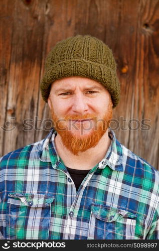 Portrait of a red haired hipster guy putting silly face