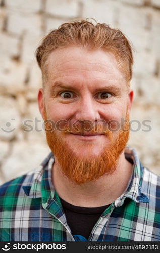 Portrait of a red haired man in a rural enviroment