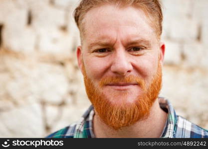 Portrait of a red haired man in a rural enviroment