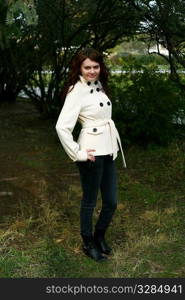 Portrait of a redheaded girl near a tree (autumn colors).