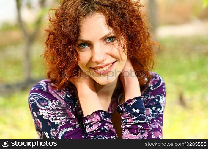 Portrait of a redheaded girl near a tree (split toning).