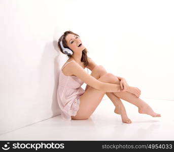 Portrait of a relaxed, sensual woman listening to music