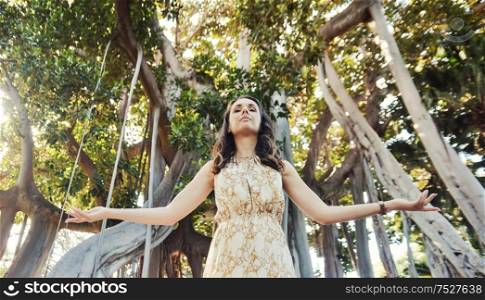 Portrait of a relaxed woman posing over the tropical forest