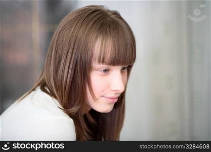 Portrait of a relaxed young woman smiling indoors