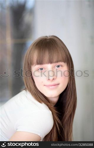 Portrait of a relaxed young woman smiling indoors