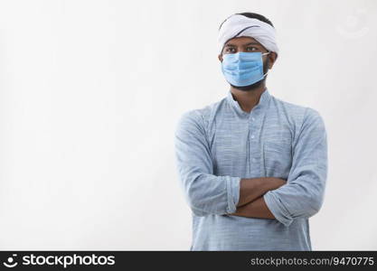 PORTRAIT OF A RURAL MAN WITH WHITE TURBAN ON HEAD AND WEARING A MASK