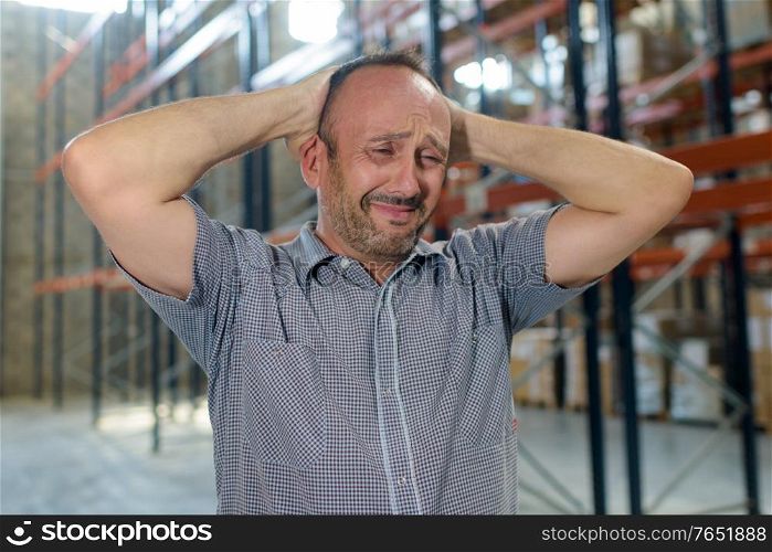 portrait of a sad man in warehouse
