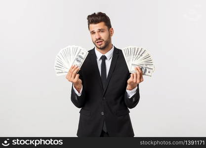 Portrait of a satisfied young businessman holding bunch of money banknotes isolated over white background. Portrait of a satisfied young businessman holding bunch of money banknotes isolated over white background.