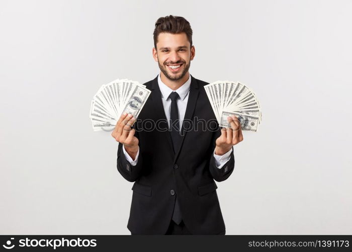 Portrait of a satisfied young businessman holding bunch of money banknotes isolated over white background. Portrait of a satisfied young businessman holding bunch of money banknotes isolated over white background.