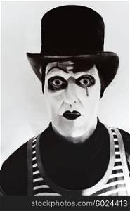 Portrait of a scary angry mime wearing a tall hat
