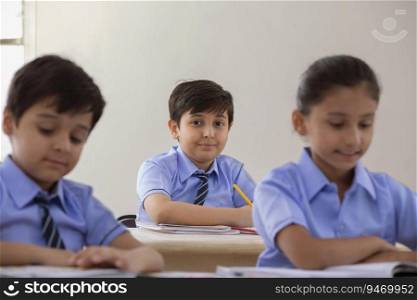portrait of a school boy sitting in class and smiling