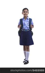 portrait of a school girl holding bag and smiling 