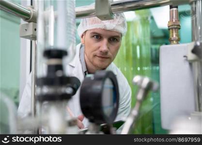 Portrait of a scientist, apothecary extracting cannabis oil using scientific equipment in a laboratory. Concept of cannabis extraction for alternative medicinal treatment. Portrait of a scientist, apothecary extracting cannabis oil in laboratory.