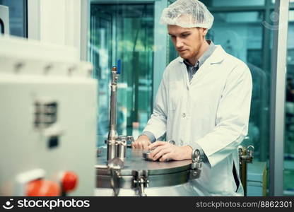 Portrait of a scientist, apothecary extracting cannabis oil using scientific equipment in a laboratory. Concept of cannabis extraction for alternative medicinal treatment. CBD oil extraction concept.. Portrait of a scientist, apothecary extracting cannabis oil in laboratory.