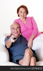 Portrait of a senior couple watching television