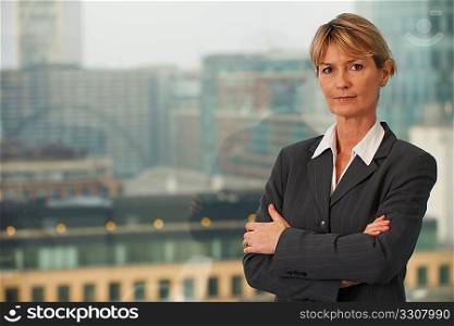 Portrait of a senior executive by a window looking at camera with space for copy