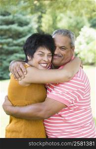 Portrait of a senior man embracing with a mature woman and smiling