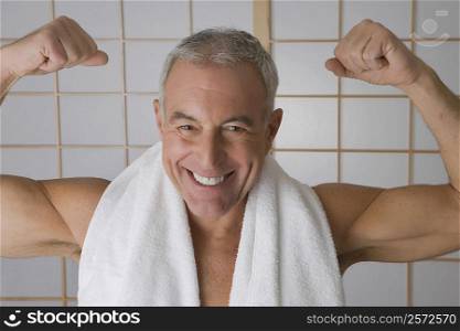 Portrait of a senior man flexing his muscles