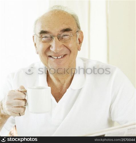Portrait of a senior man holding a coffee cup