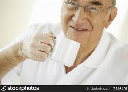 Portrait of a senior man holding a coffee cup