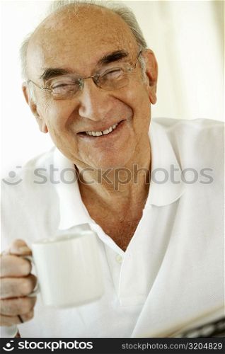 Portrait of a senior man holding a cup of coffee