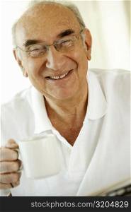 Portrait of a senior man holding a cup of coffee