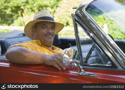 Portrait of a senior man in a convertible car