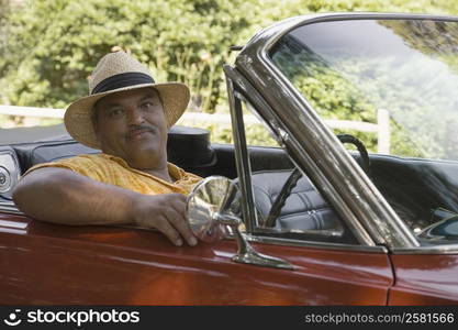 Portrait of a senior man sitting in a convertible car