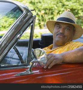 Portrait of a senior man sitting in a convertible car