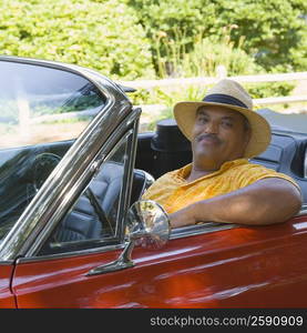 Portrait of a senior man sitting in a convertible car