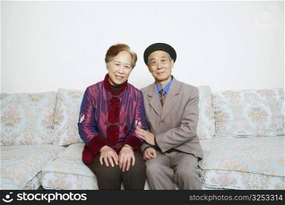 Portrait of a senior man sitting on a couch with a mature woman