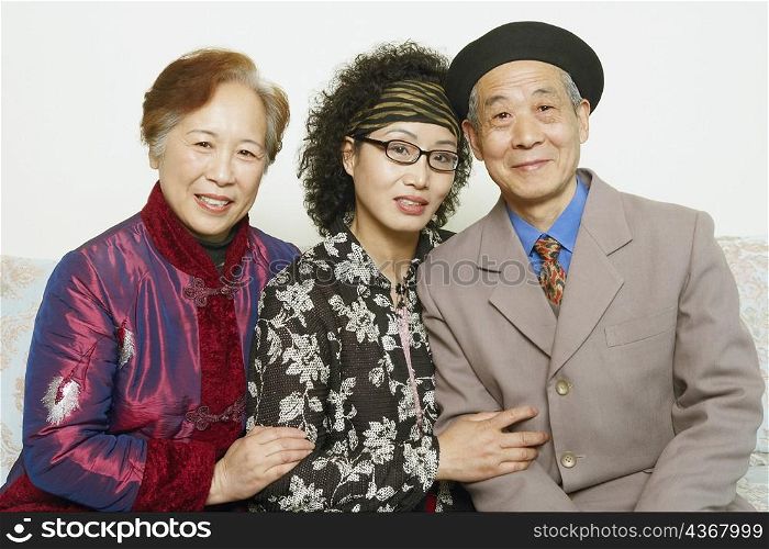 Portrait of a senior man sitting on a couch with two mature women