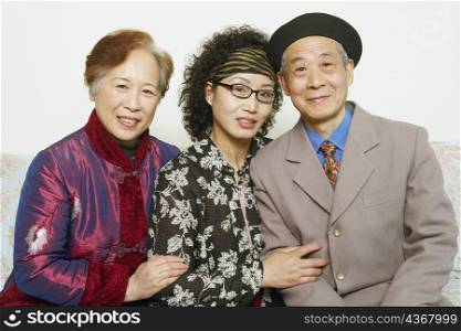 Portrait of a senior man sitting on a couch with two mature women