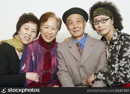 Portrait of a senior man sitting with three mature women