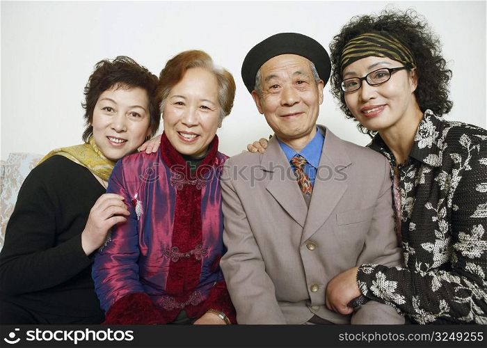 Portrait of a senior man sitting with three mature women