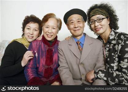 Portrait of a senior man sitting with three mature women