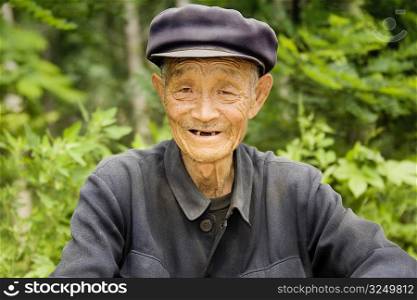 Portrait of a senior man smiling, Zhigou, Shandong Province, China