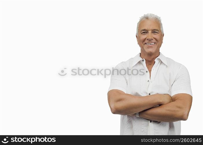 Portrait of a senior man standing with his arms crossed and smiling