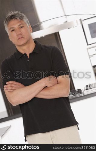 Portrait of a senior man standing with his arms folded