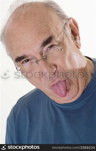 Portrait of a senior man sticking out his tongue