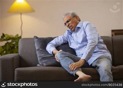 Portrait of a senior man suffering from knee pain  