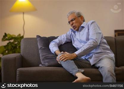 Portrait of a senior man suffering from knee pain 